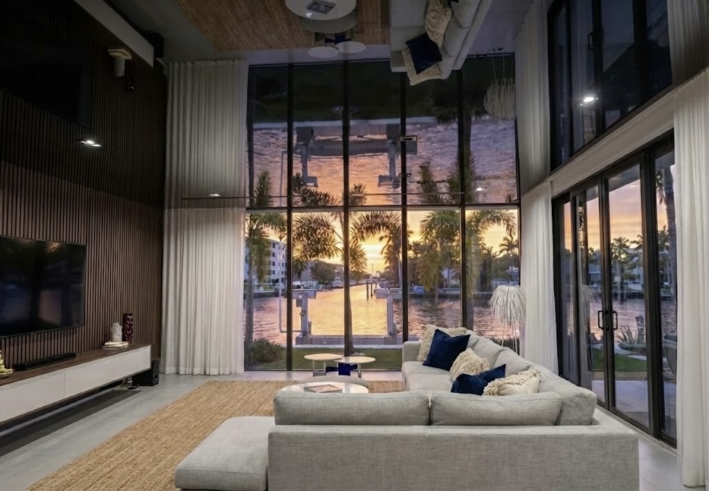 Luxury living room with reflective high gloss stretch ceiling mirroring the space and lighting